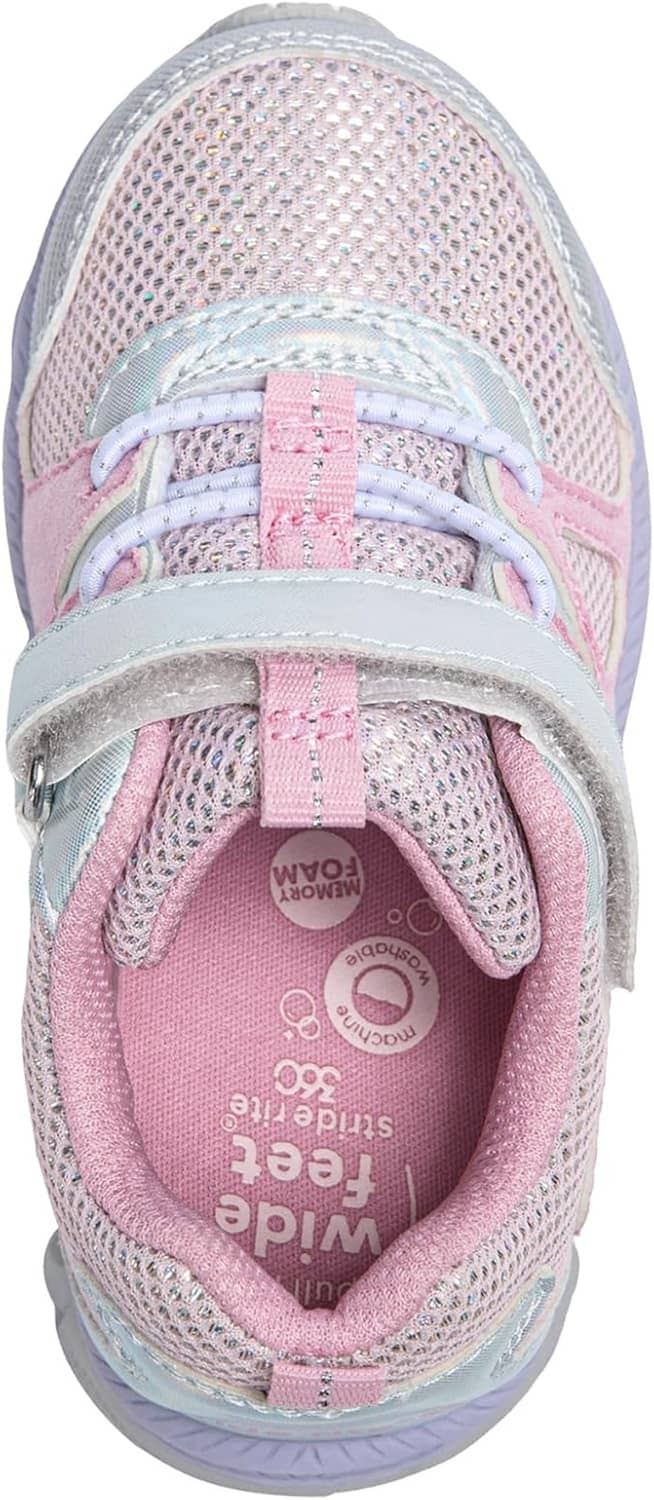 Inner lining of light pink and silver toddler sneakers with padded collar and branded logo