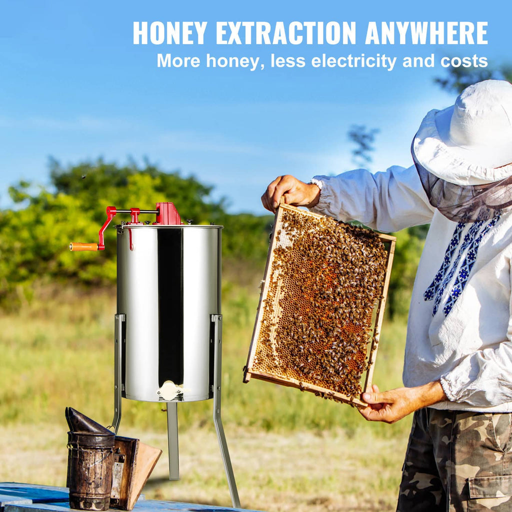 Stainless steel honey extractor with red crank, outdoors, plus a beekeeper holding a honey frame