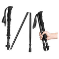 Collapsible trekking pole in dark color with folding handle and wrist strap, extended view