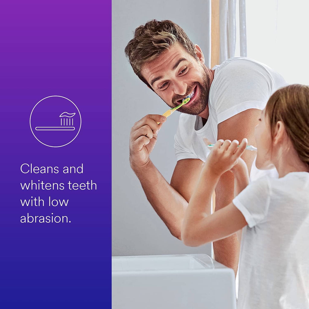 Anti-cavity fluoride toothpaste for brushing, toothbrush held by father and child