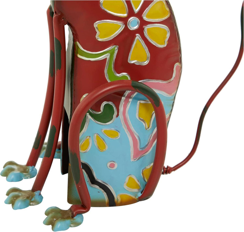 Decorative metal dog statue, close side view, red body with blue and yellow floral patterns