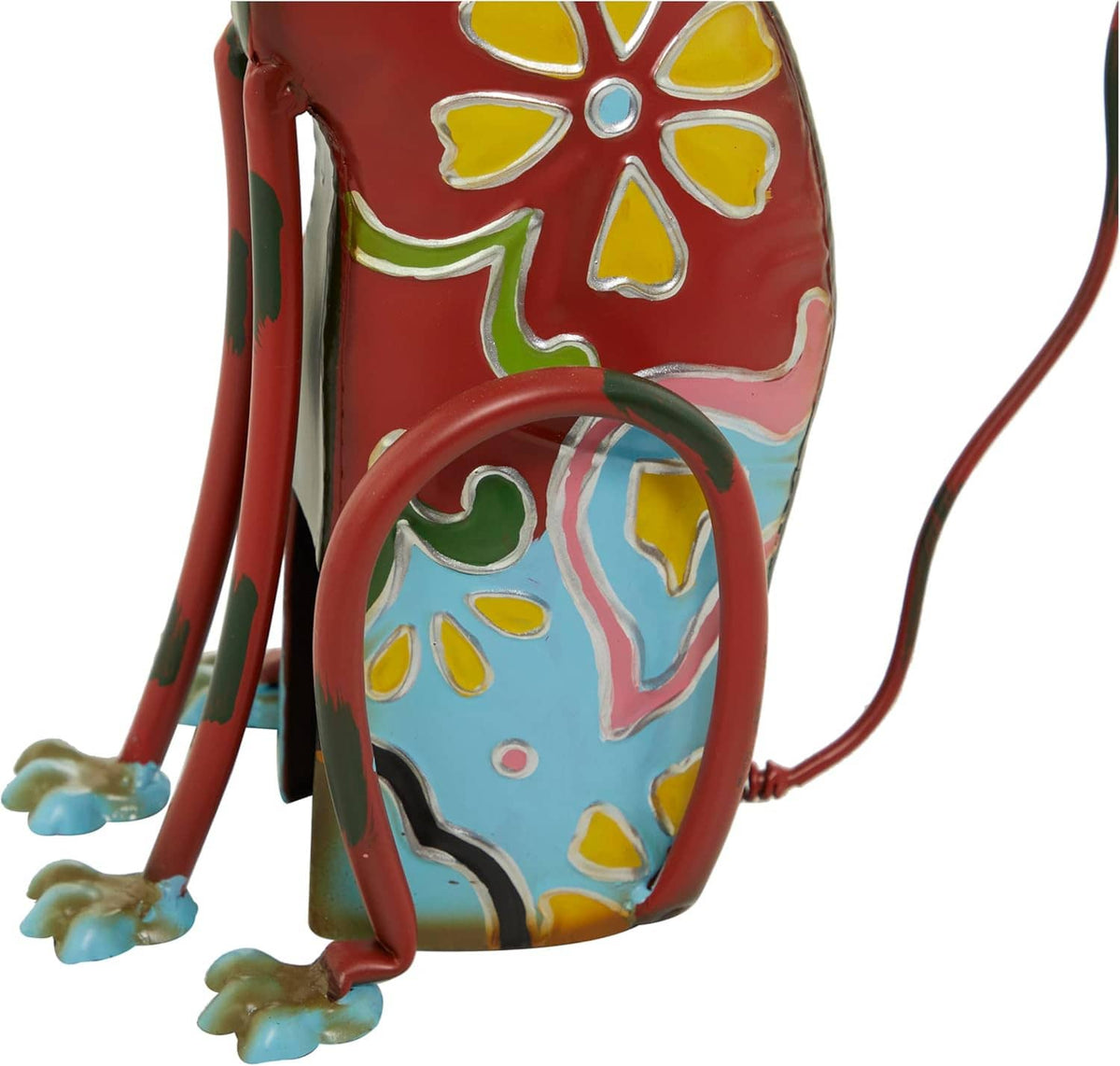Decorative metal dog statue, close side view, red body with blue and yellow floral patterns