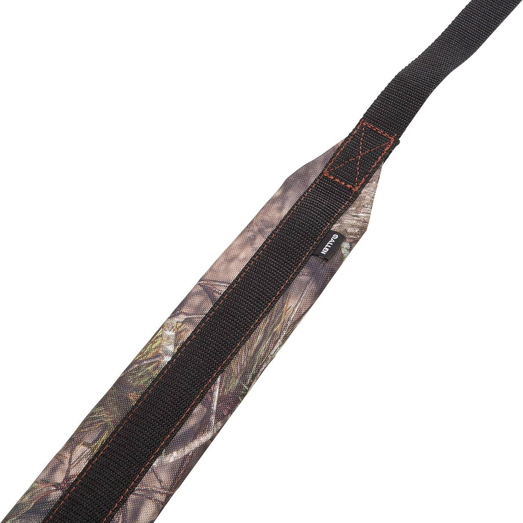 Camouflage padded gun sling strap with black center band and orange diamond-stitch detail