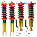 Gold coilover strut shocks with red coil springs and adjustable top mounts