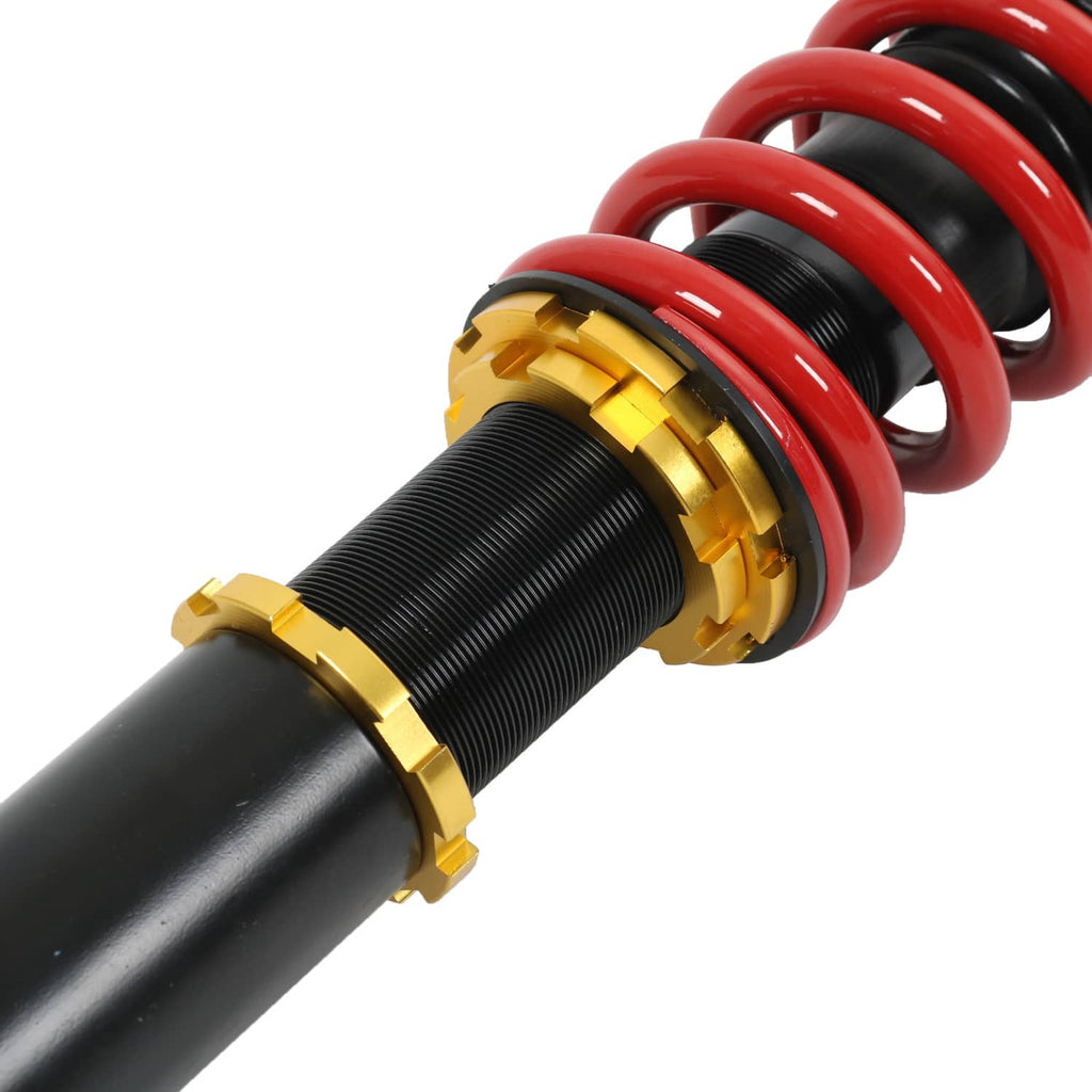 Coilover shock with threaded black body, gold adjuster rings, and red spring