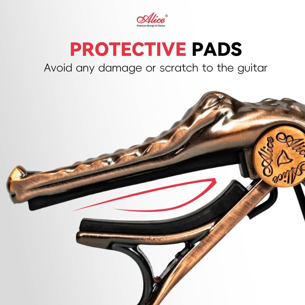 Bronze alligator-style capo clamp with black protective pad, close-up