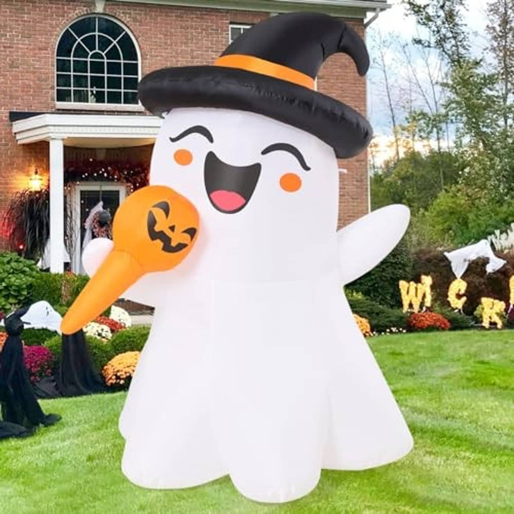 White inflatable ghost with black witch hat and orange jack-o-lantern, front view in yard