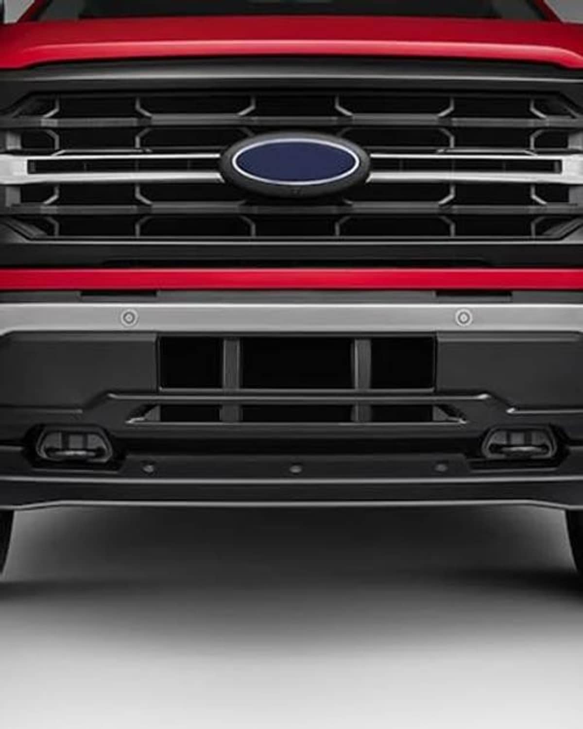 Front grille with oval blue emblem and lower grille openings in black