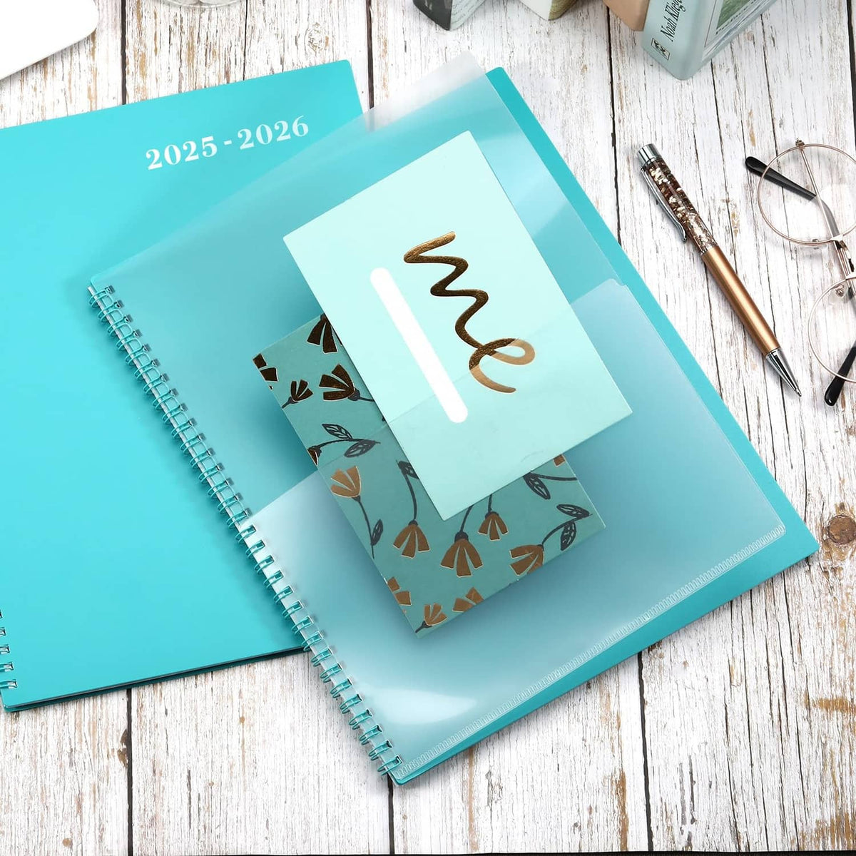 Turquoise 2025-2026 planner with spiral binding and a cover label pocket for cards