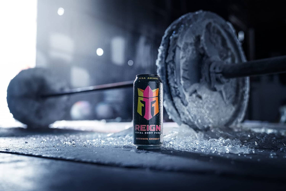 Reignbow Sherbet fitness drink can near dumbbell on gym floor
