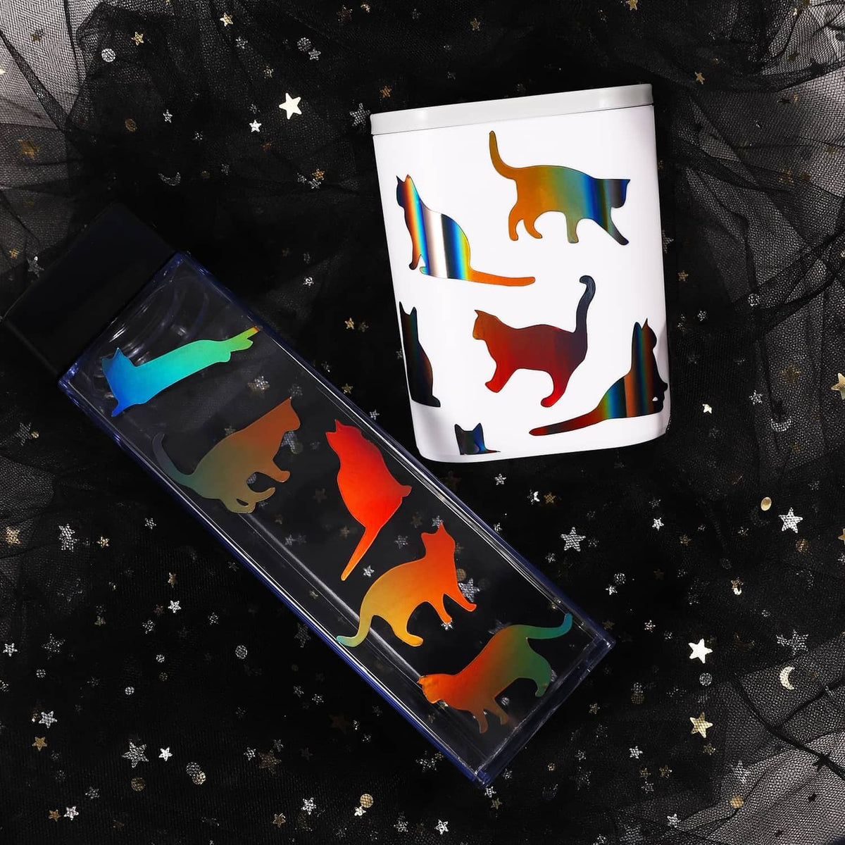 Holographic vinyl decal sheet with cut animal silhouettes, glossy black base