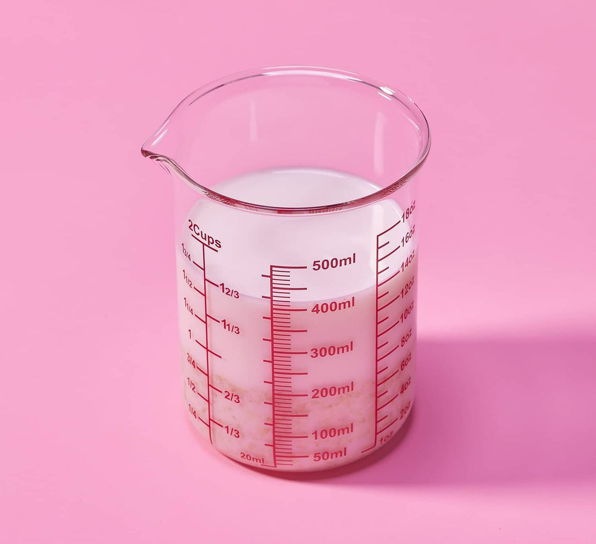 Clear glass 2-cup measuring cup with red measurement lines and V-shaped spout