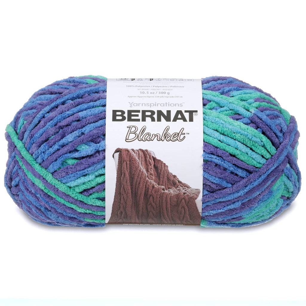 Super bulky yarn skein in variegated blue, green, and purple stripes with label