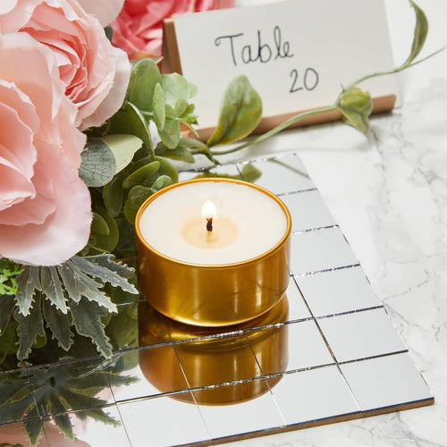 Square glass mirror tiles arranged in a grid under a gold candle
