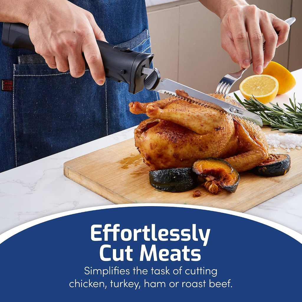 Cordless electric knife cutting roasted chicken, black handle and serrated blade