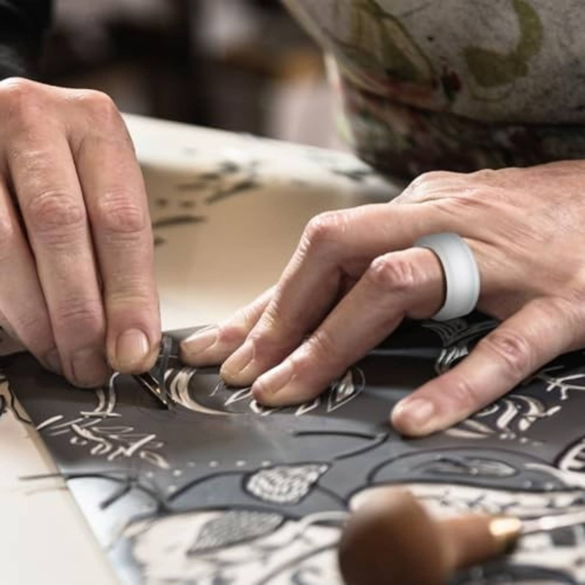 White silicone ring cover being fitted by hands, with black band and LED window
