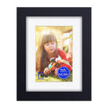 Black wooden picture frame with white mat and portrait photo under glass