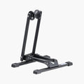 Collapsible black bicycle stand with front wheel cradle and foldable base legs