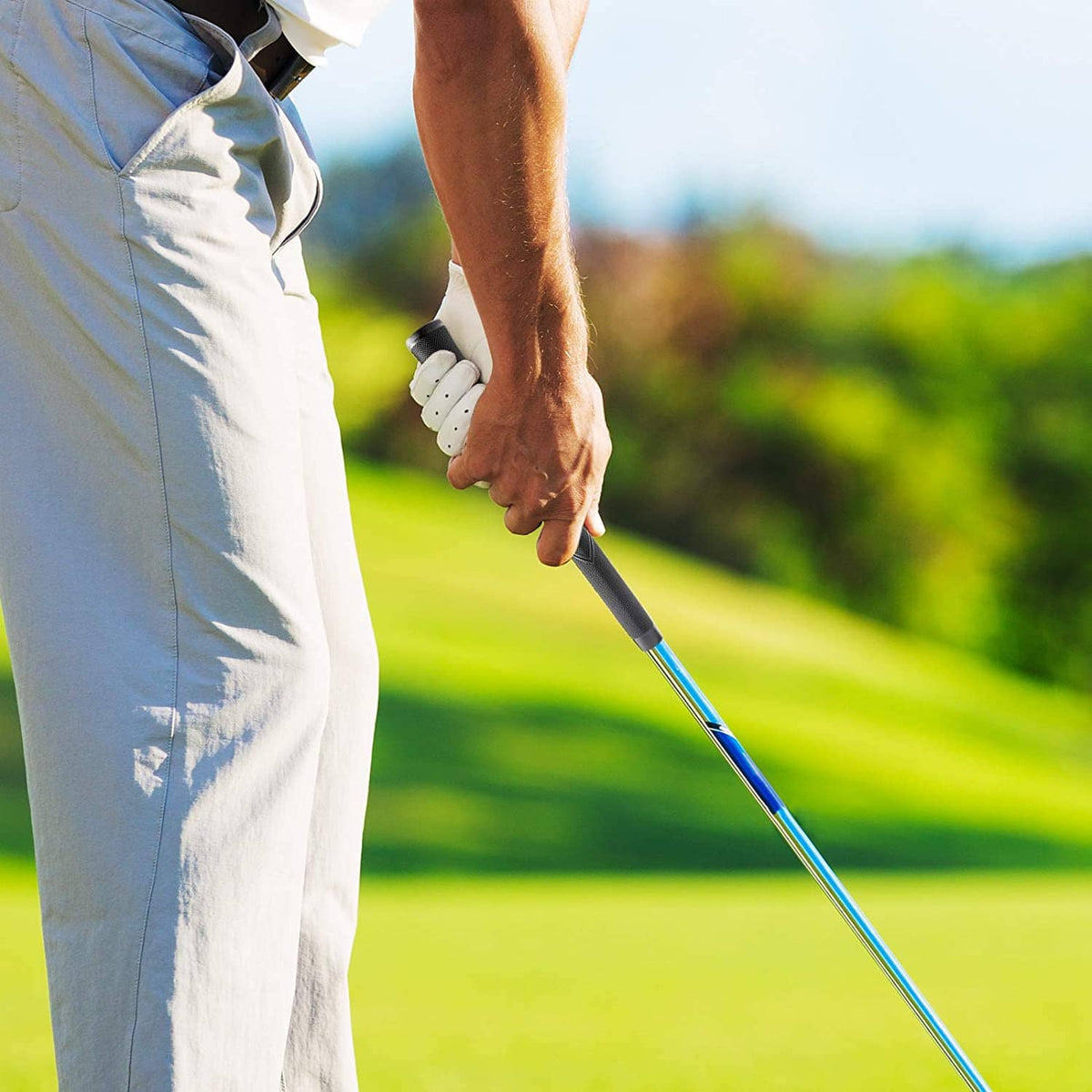 Golfer holding a golf club with a black oversized grip
