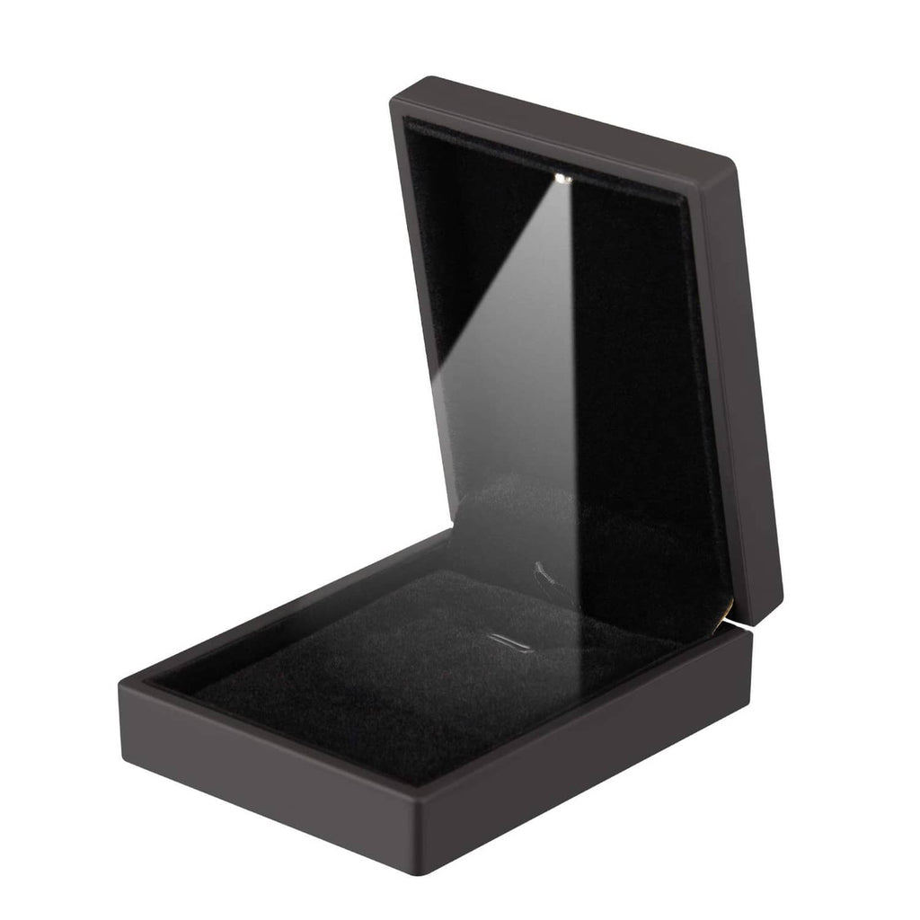 Black velvet jewelry display box with open lid and empty velvet insert