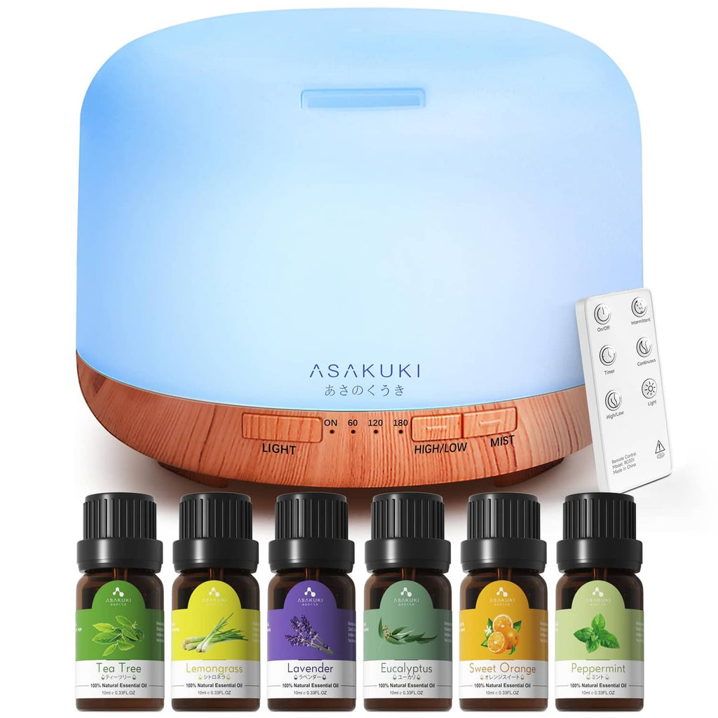 Essential oil diffuser with light blue top, wood base, and mist control dial