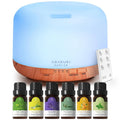 Essential oil diffuser with light blue top, wood base, and mist control dial