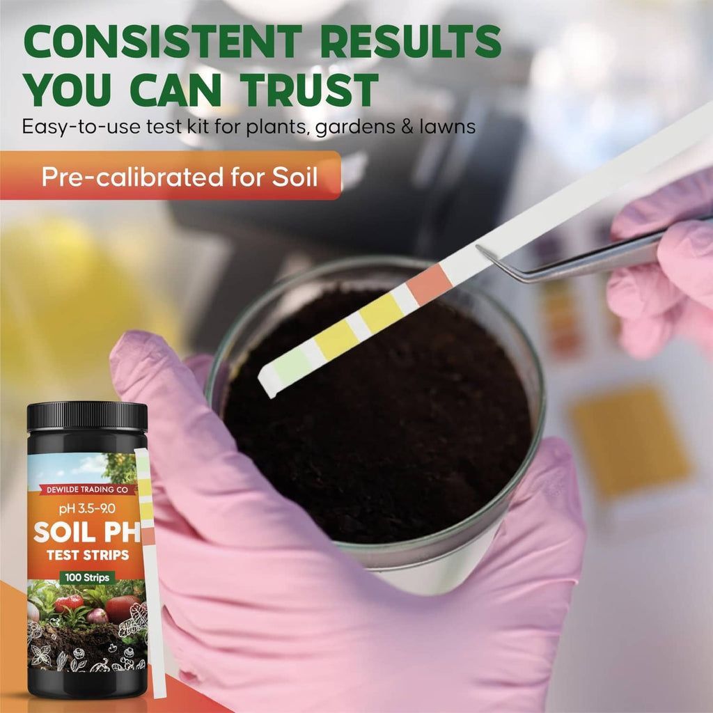 Soil pH test strip dipping into soil-filled cup held by gloved hands