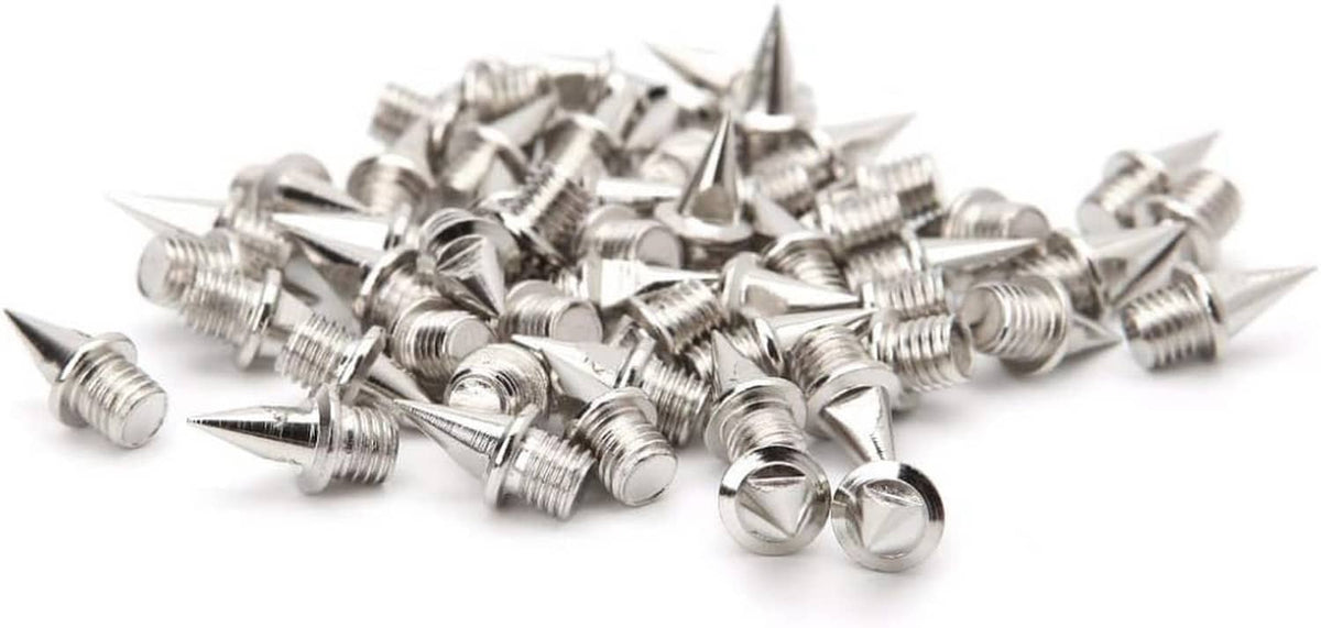 Stainless steel replacement track spike set with pointed tips, threaded bases, and green wrench