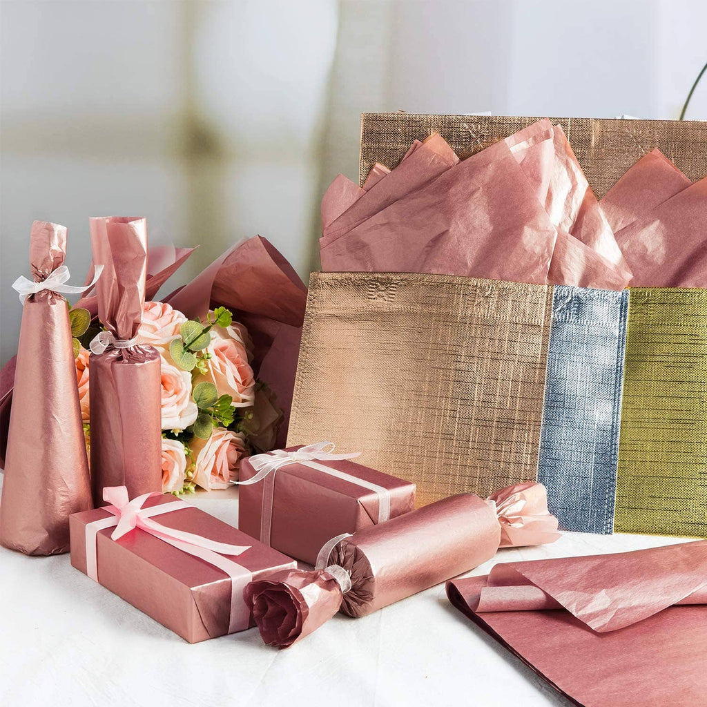 Rose gold metallic tissue paper sheets with gift bows on wrapped presents