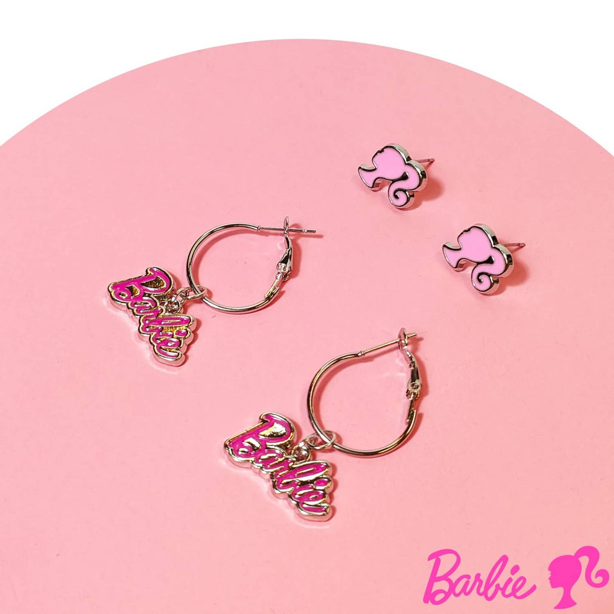 Barbie hot pink face studs and hoop earrings with 'Barbie' charms, set layout