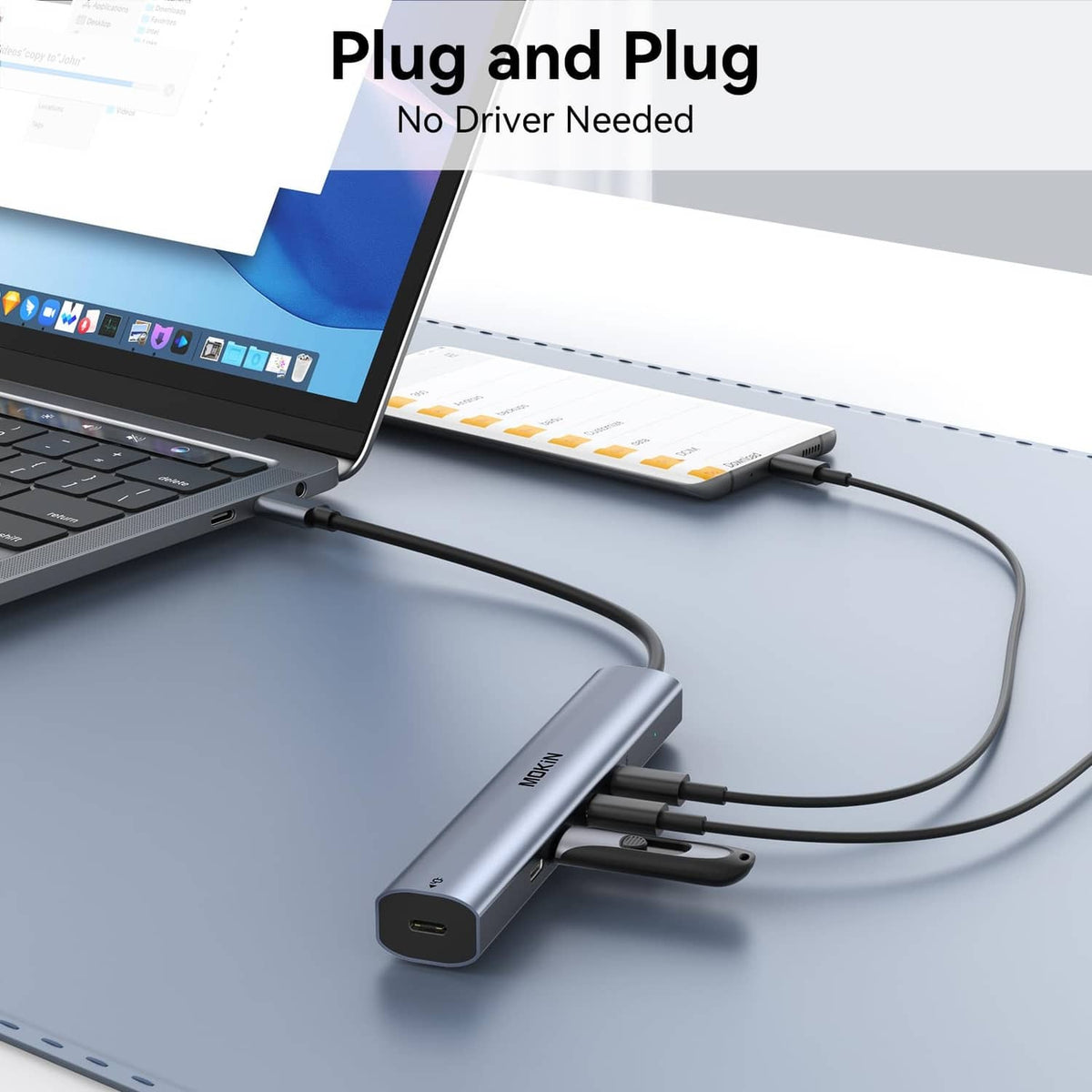 USB-C hub connected to a laptop with several accessory cables plugged in