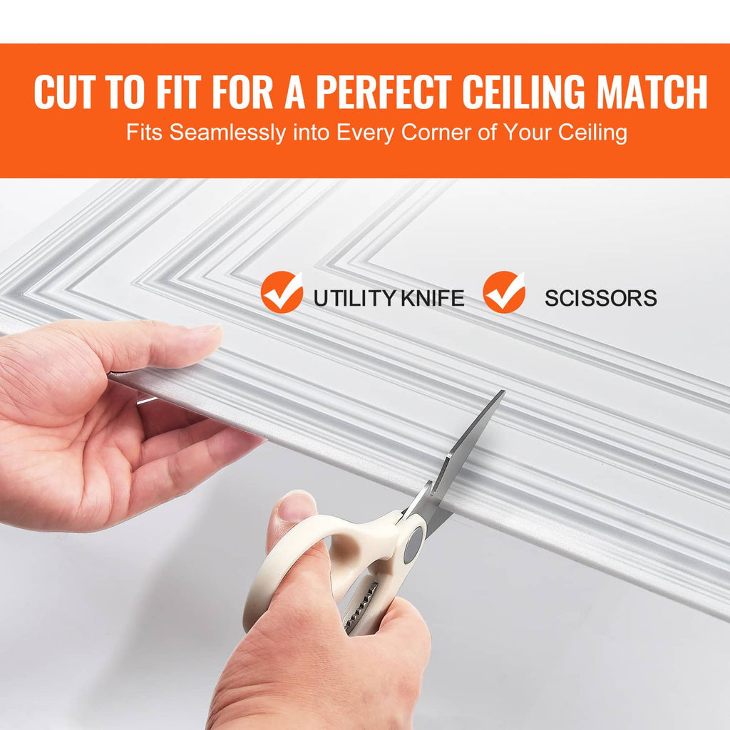 White PVC ceiling tile being cut to fit, with utility knife and scissors beside it