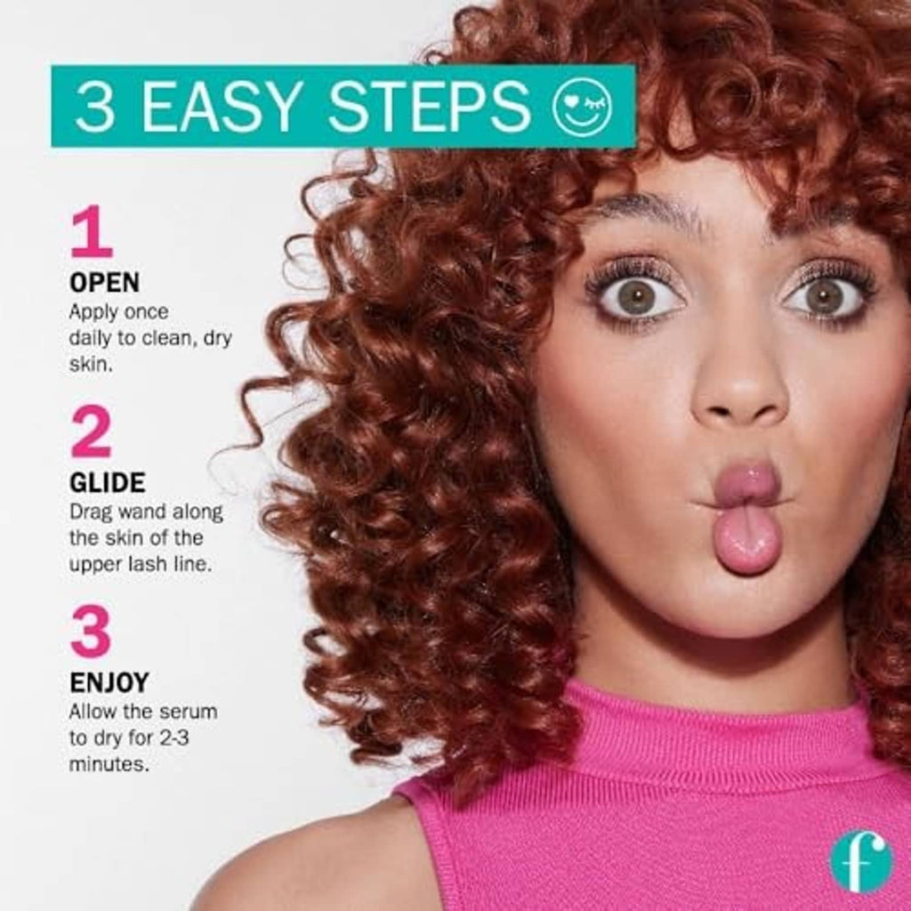 Woman with curly hair and bold lashes, applying lash serum along upper lash line