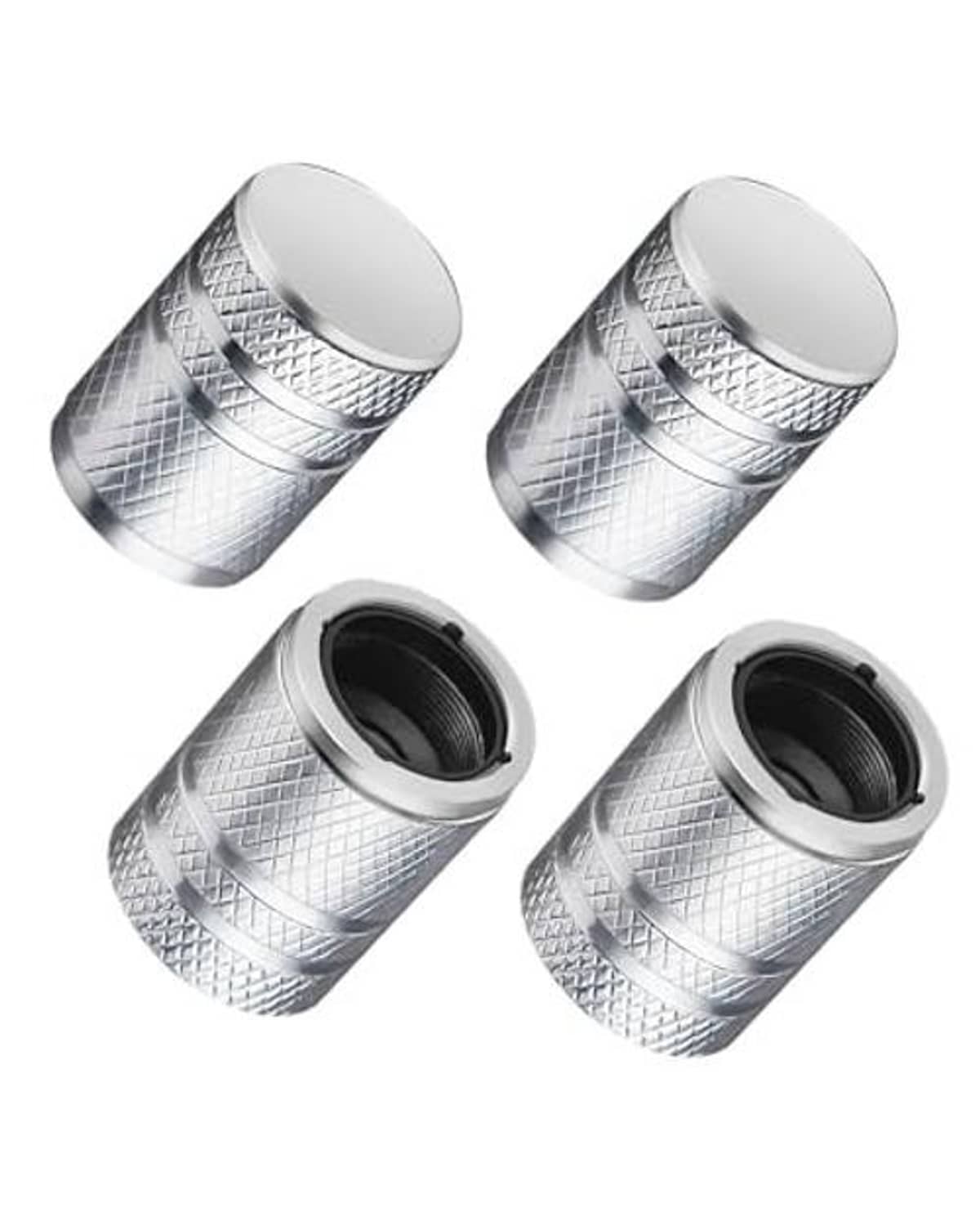 Four silver tire valve stem caps with textured metal body and black rubber liner