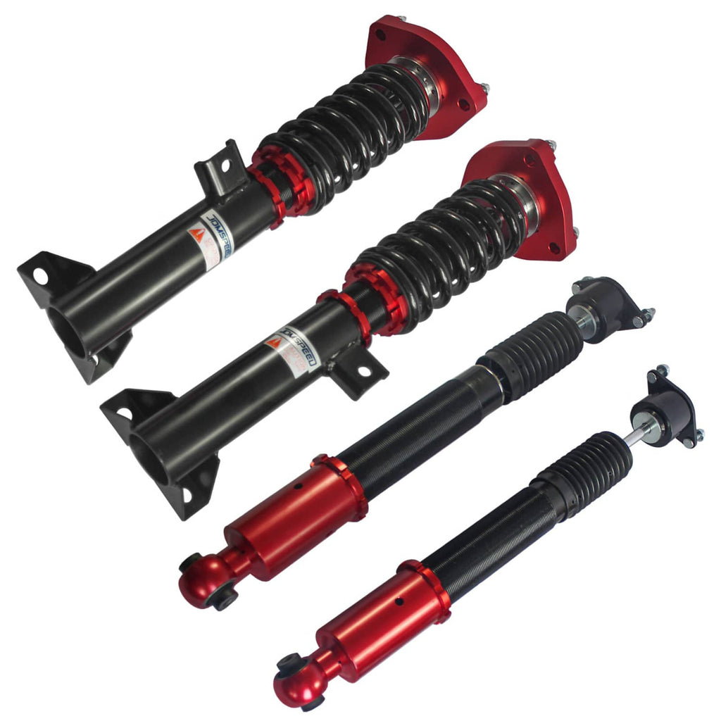 Four-piece coilover suspension set with black shocks, red cylinders, and coil springs