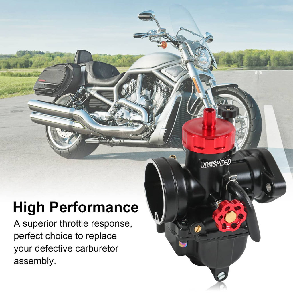 Black carburetor with red top cap and adjustment housing, shown attached near motorcycle