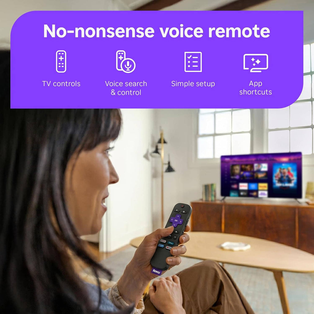 Roku voice remote in hand in front of TV showing streaming content