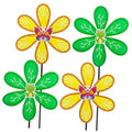Set of four garden wind spinners with green and yellow petals and butterfly centers
