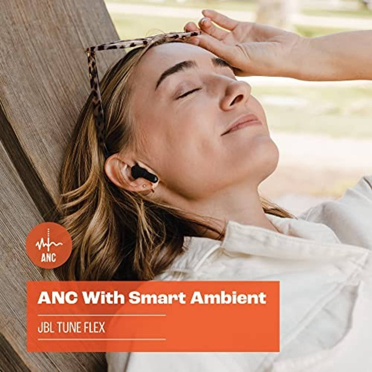 Black JBL true wireless earbuds in ear, close portrait view