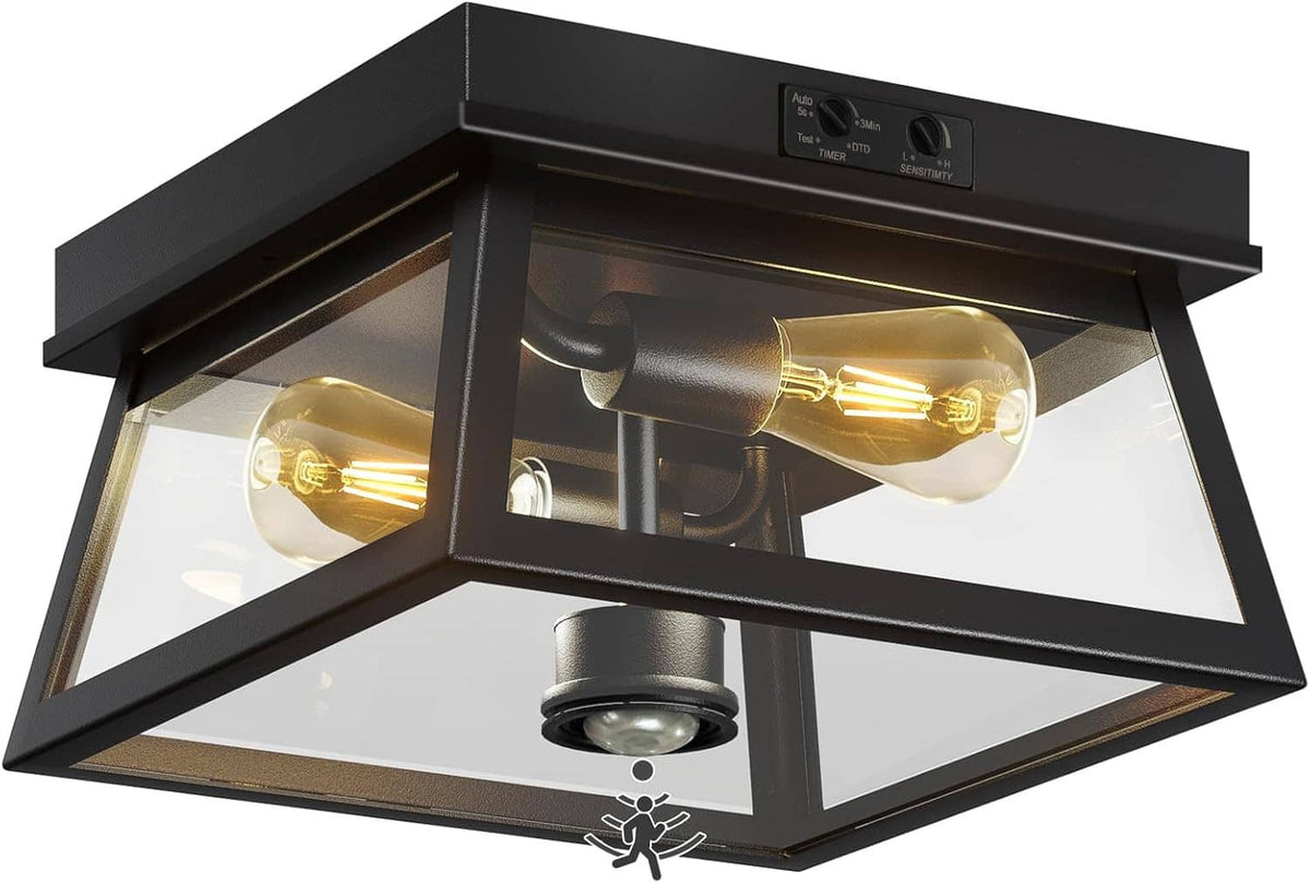 Black flush mount outdoor ceiling light with two amber Edison-style bulbs and motion sensor