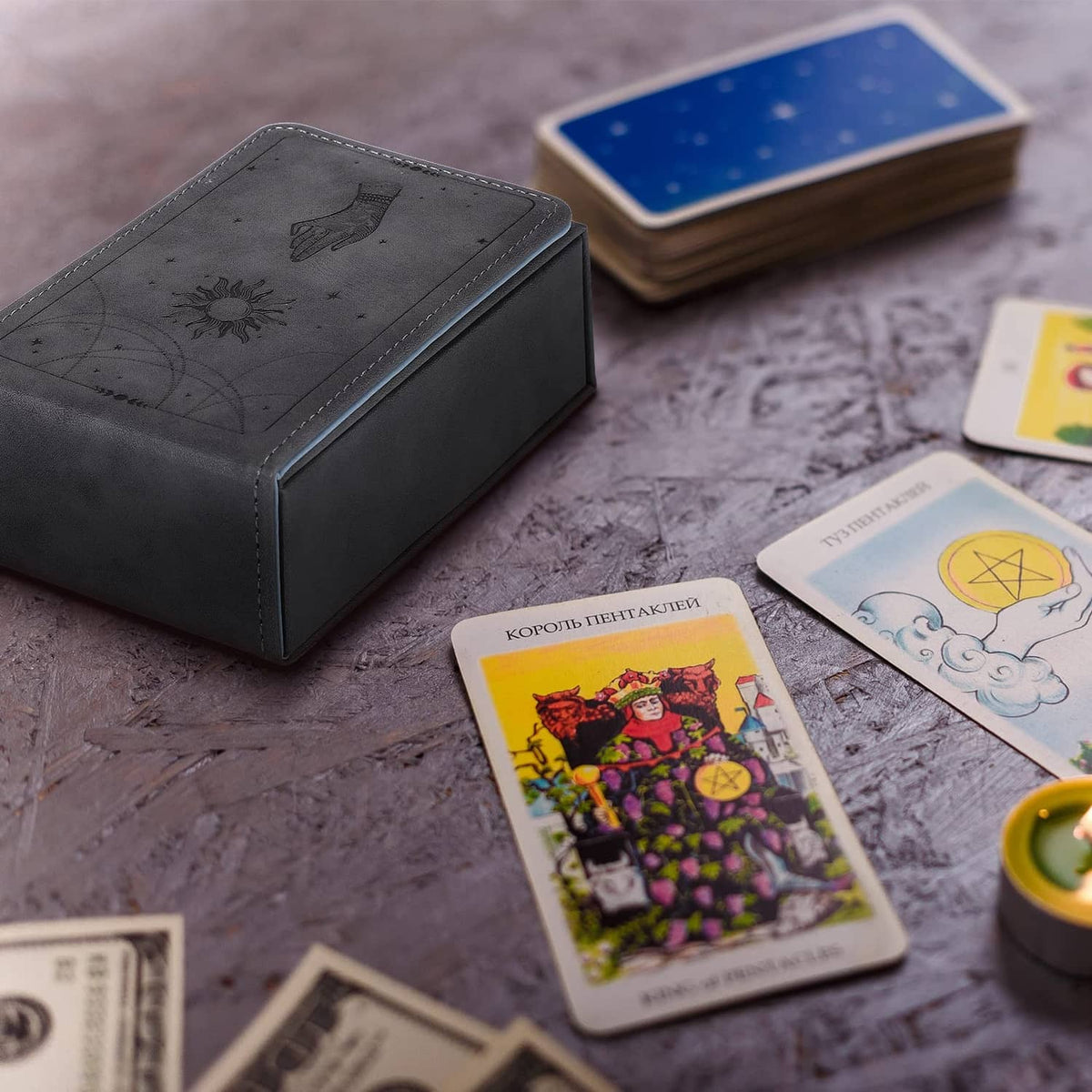 Grey tarot card case with embossed celestial hand and moon graphic, holds playing cards