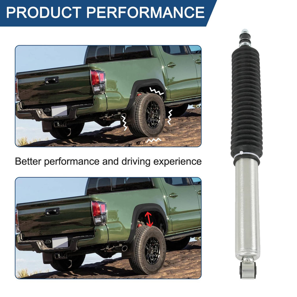 Rear shock absorber with black boot and silver body beside pickup truck rear wheel
