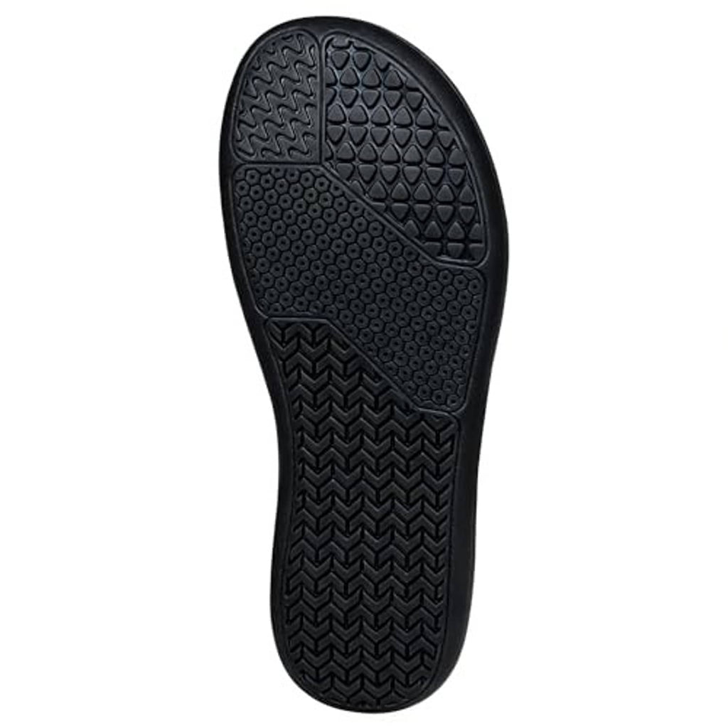 Dark slipper outsole with traction tread and molded rubber pattern