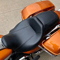 Black driver and passenger motorcycle seat with contoured cushioning and stitched seams.