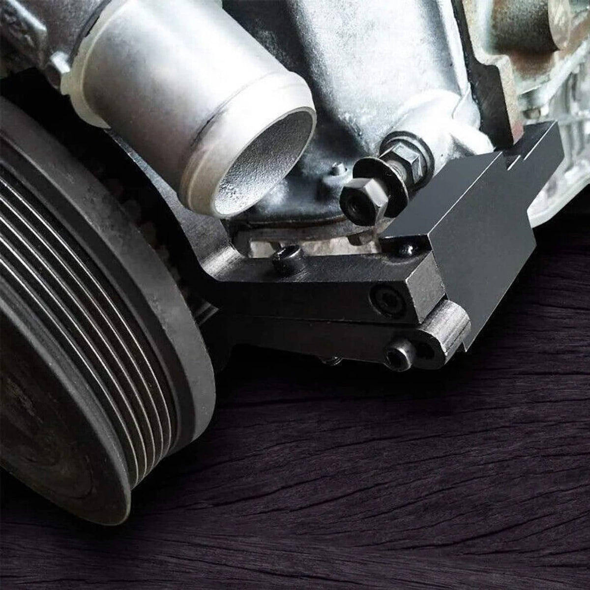 Camshaft timing tool bracket on engine camshaft area near pulley