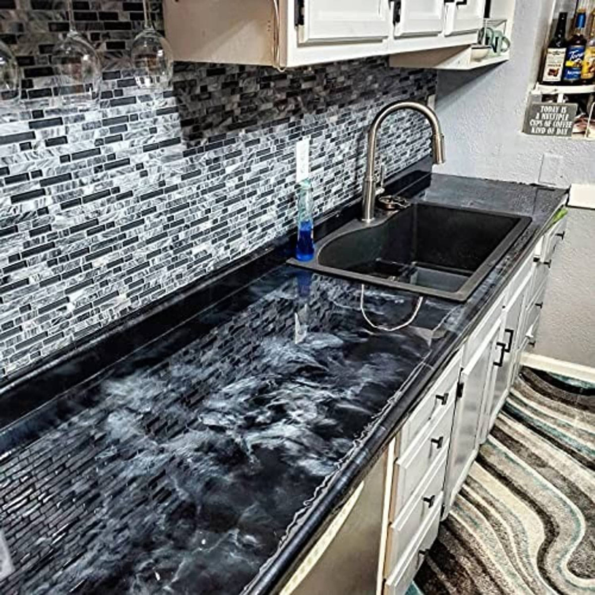 Black epoxy countertop surface with glossy waves and light veining