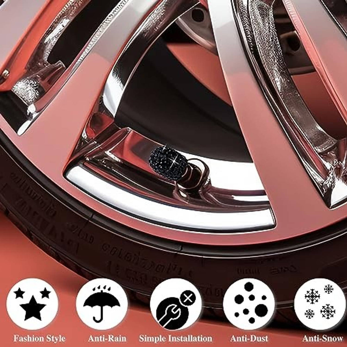 Black rhinestone tire valve caps on a wheel rim; one cap end opening visible