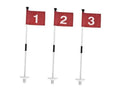 Red practice golf flags with numbered cloth markers on white poles and round bases