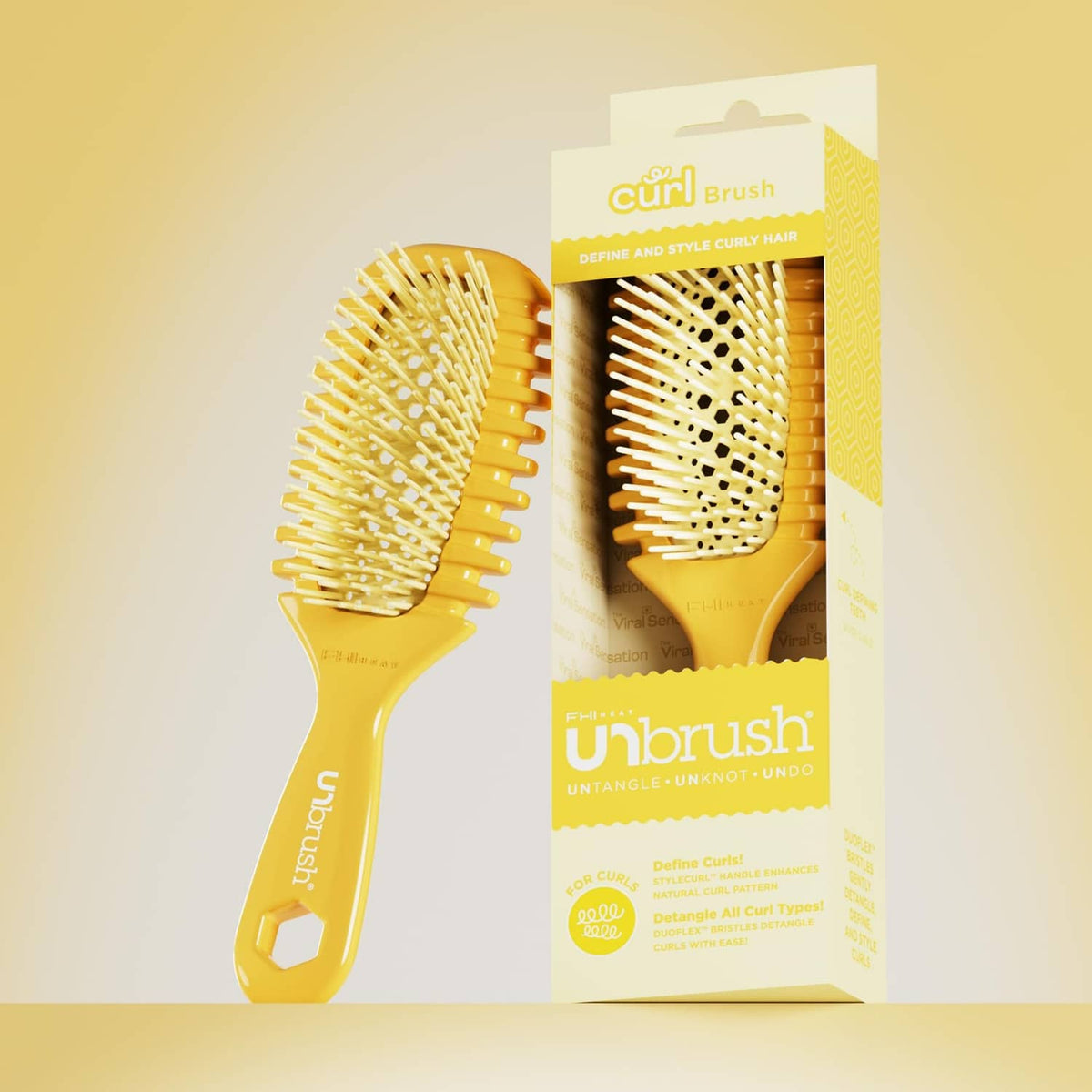 Curl brush and boxed set on display, golden bristle head and handle