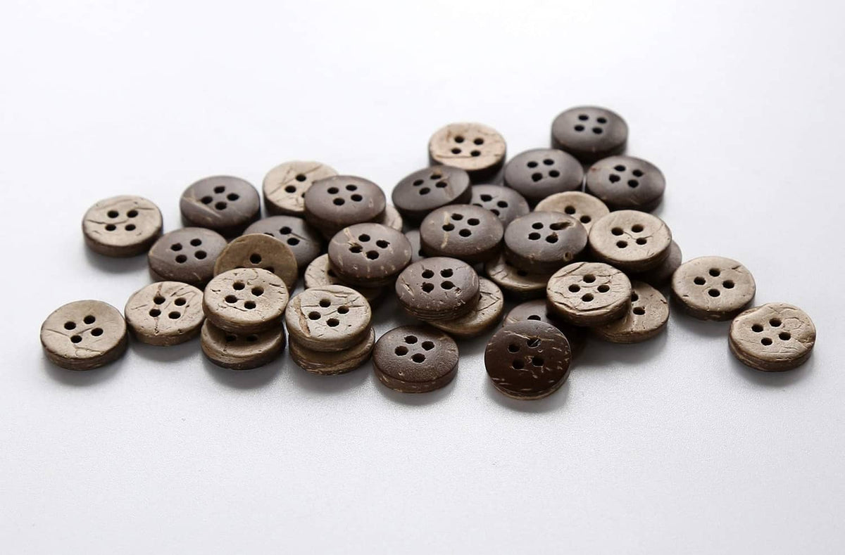 Assorted round coconut shell buttons with four holes, light and dark tones